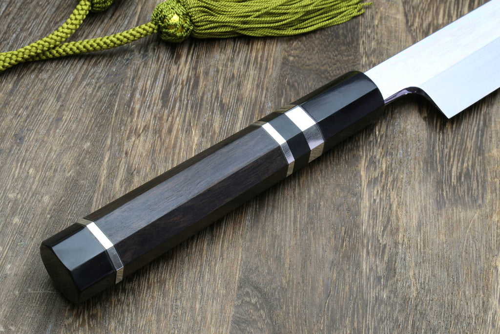 Dark handle Japanese kitchen knife with mirror-finished blade and striped grip rings