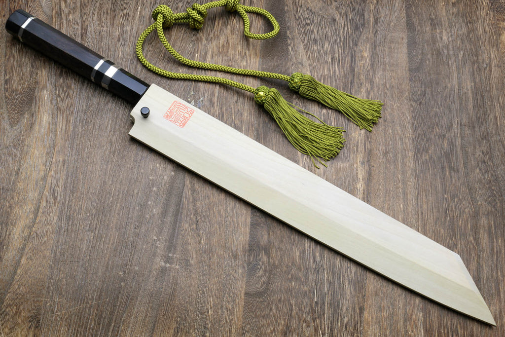 Japanese kitchen knife with dark handle, mirror-finished blade, and green cords