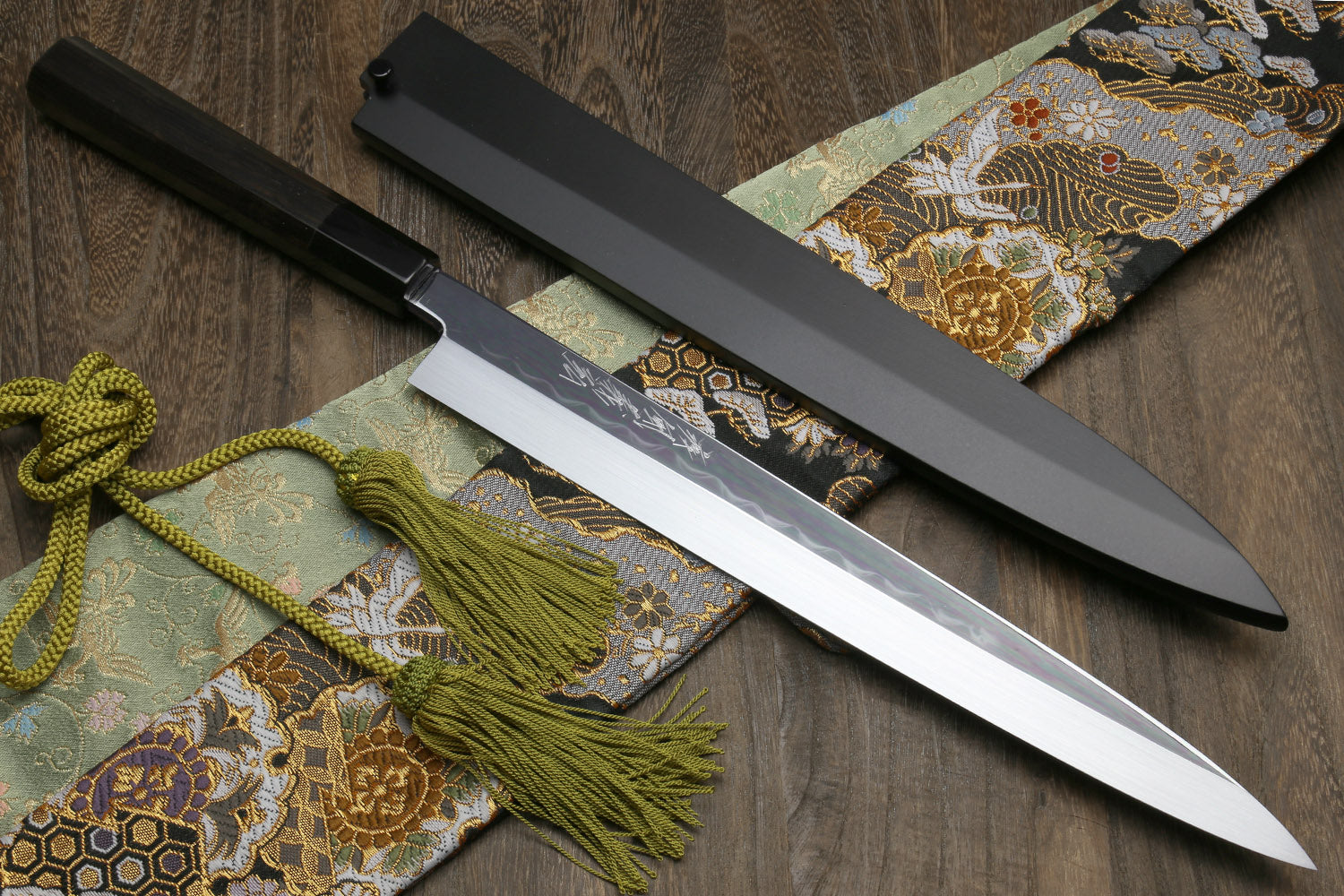 Japanese kitchen knife pair, mirror blades, black handles, ornate cloth and green tassels