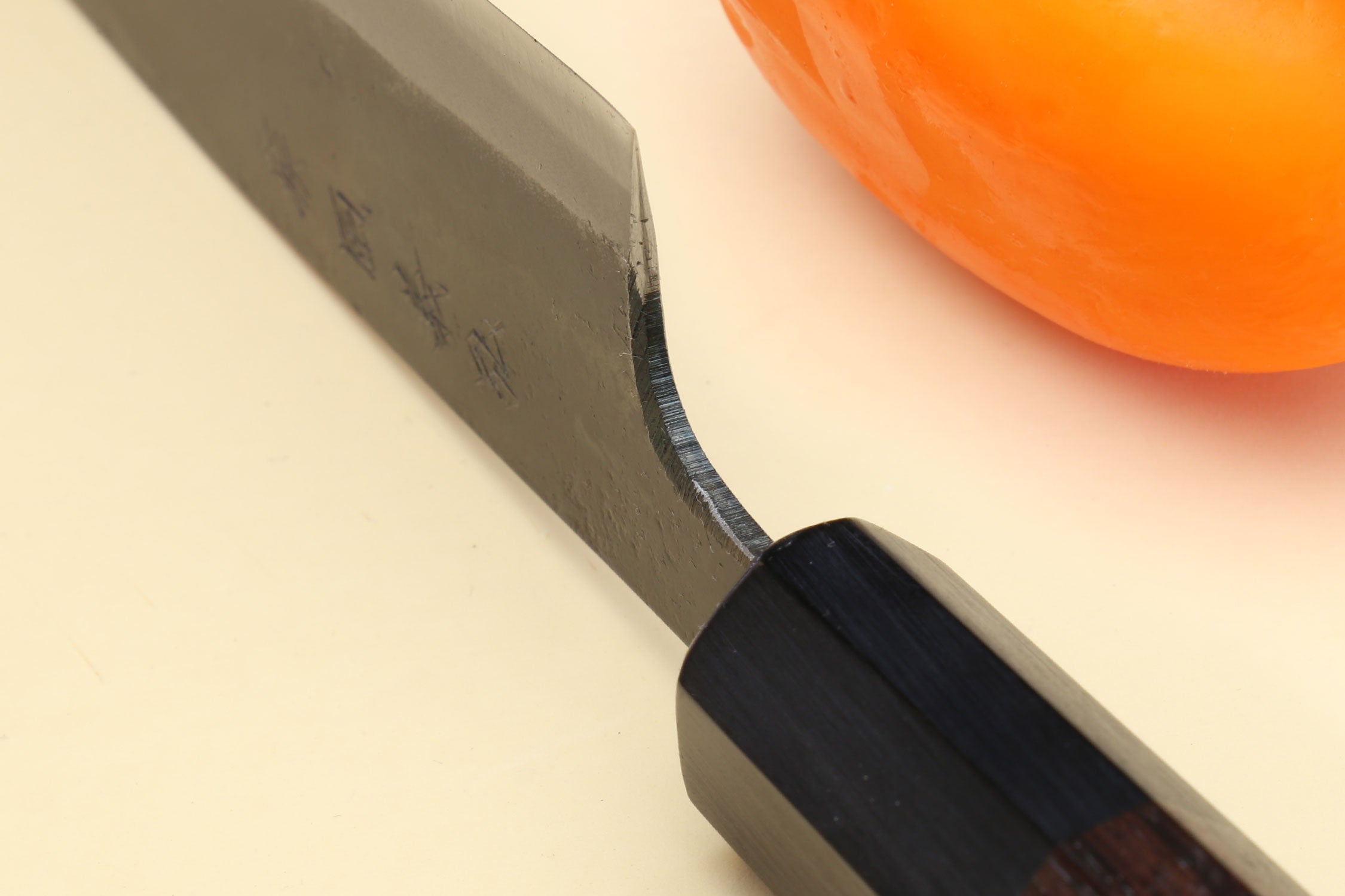 Kurouchi petty knife close-up of blade edge and dark shitan handle