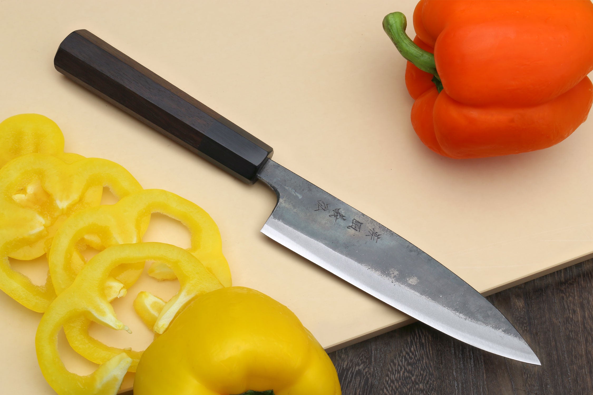 Kurouchi petty knife angled view showing blade tip and dark shitan handle