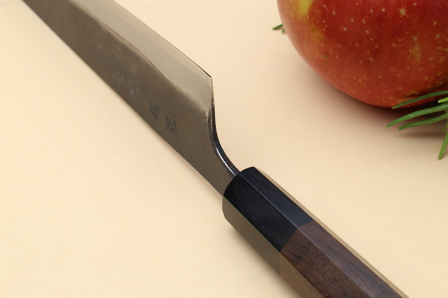 Petty kiritsuke knife end view with dark kurouchi spine and shitan handle