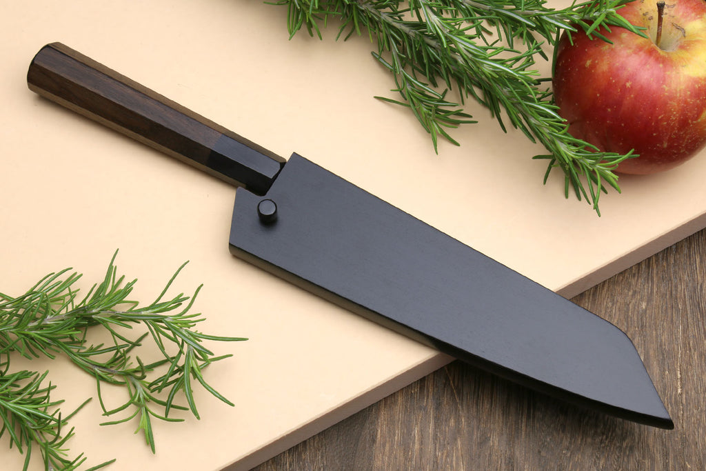 Petty kiritsuke utility knife with dark blade in saya-style cover and shitan handle