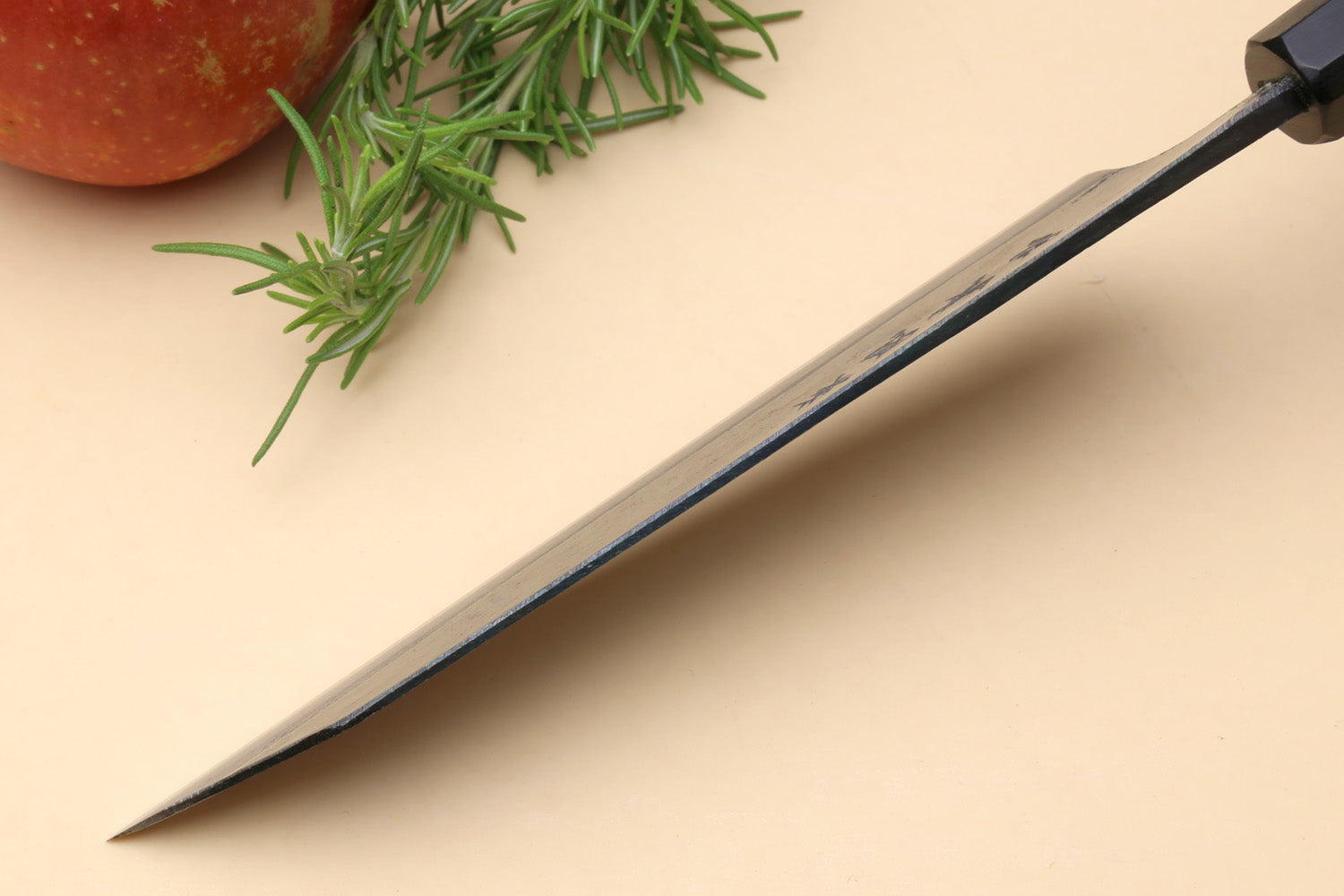 Petty kiritsuke utility knife showing straight edge and dark shitan handle