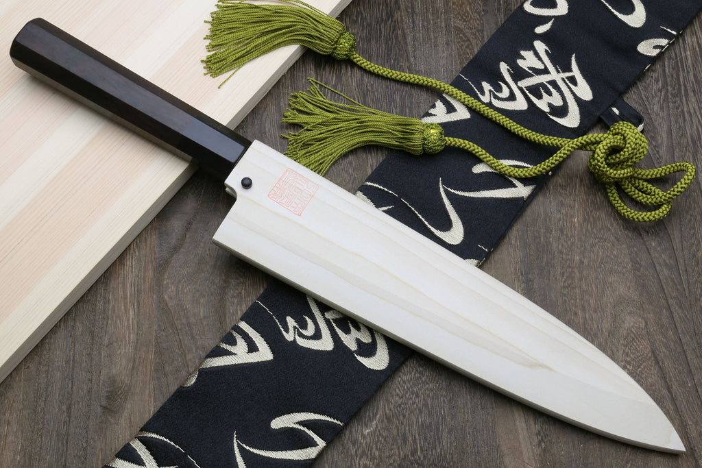 Japanese fish filet knife with ebony handle and silver blade, styled with green cord