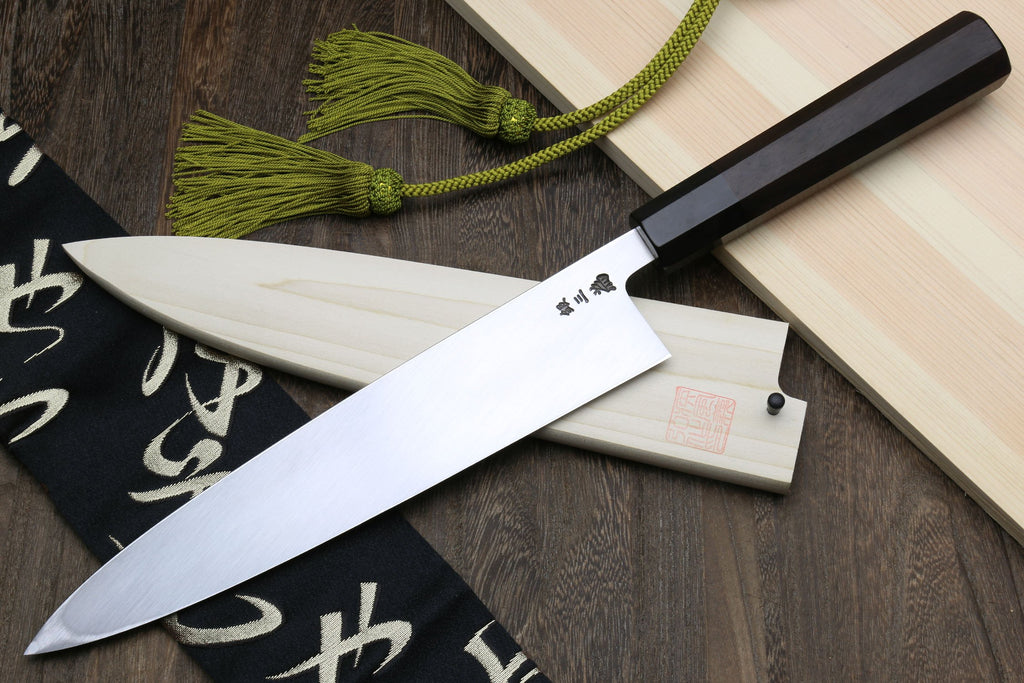 Japanese fish filet knife with ebony handle and silver blade, angled view