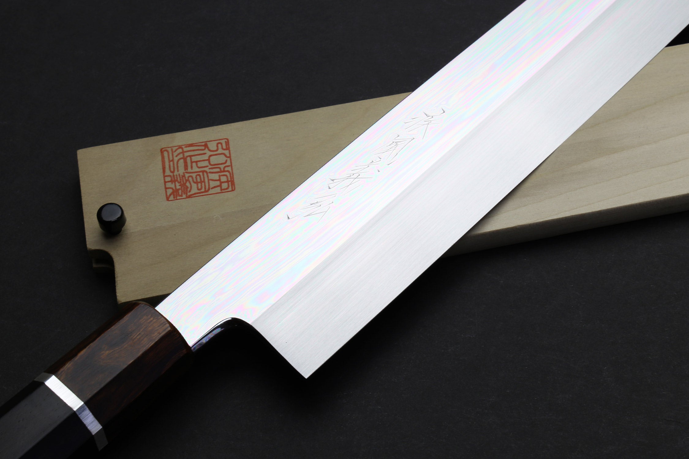 Kiritsuke knife with mirror-finished steel blade and dark wood handle with silver ring