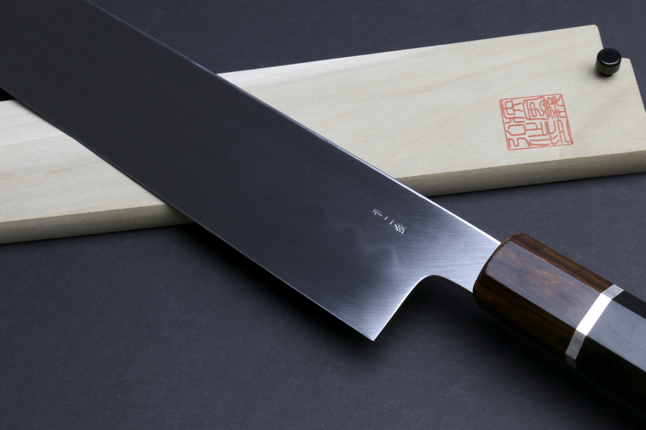 Kiritsuke multipurpose knife with dark steel blade and dark wood handle with silver ring