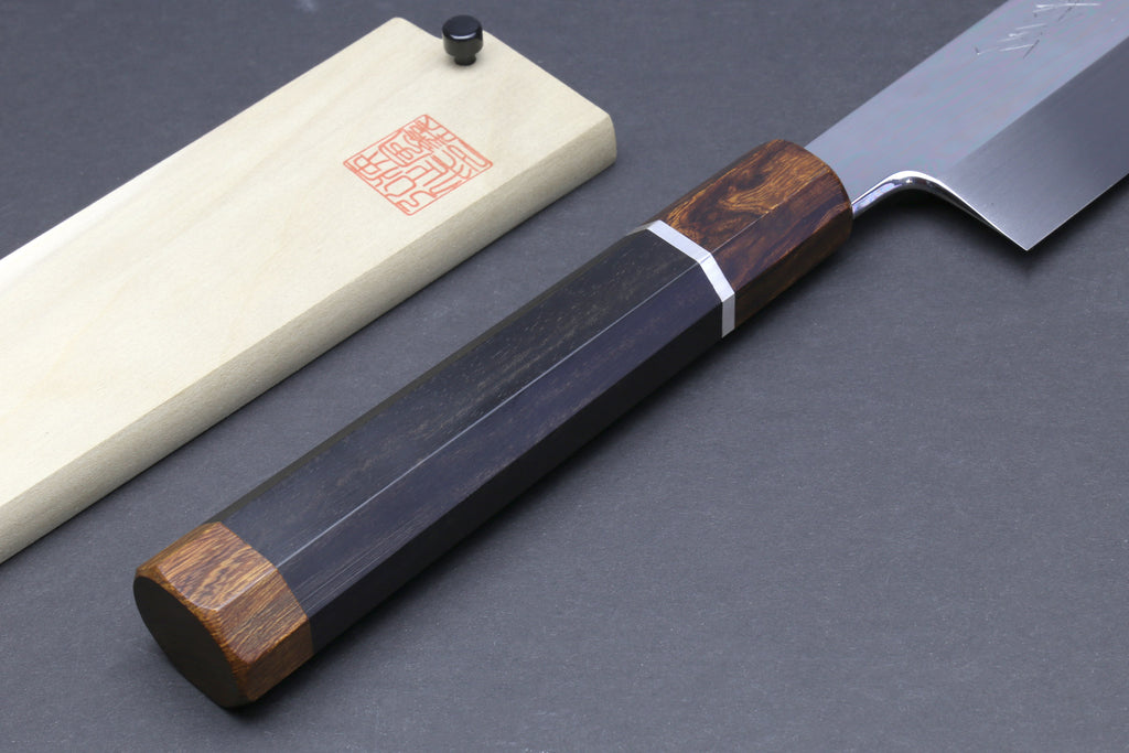 Japanese kiritsuke knife with dark indigo blade and brown handle with silver ring