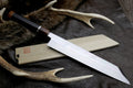 Japanese kiritsuke knife with mirror-finished silver blade and dark wood handle
