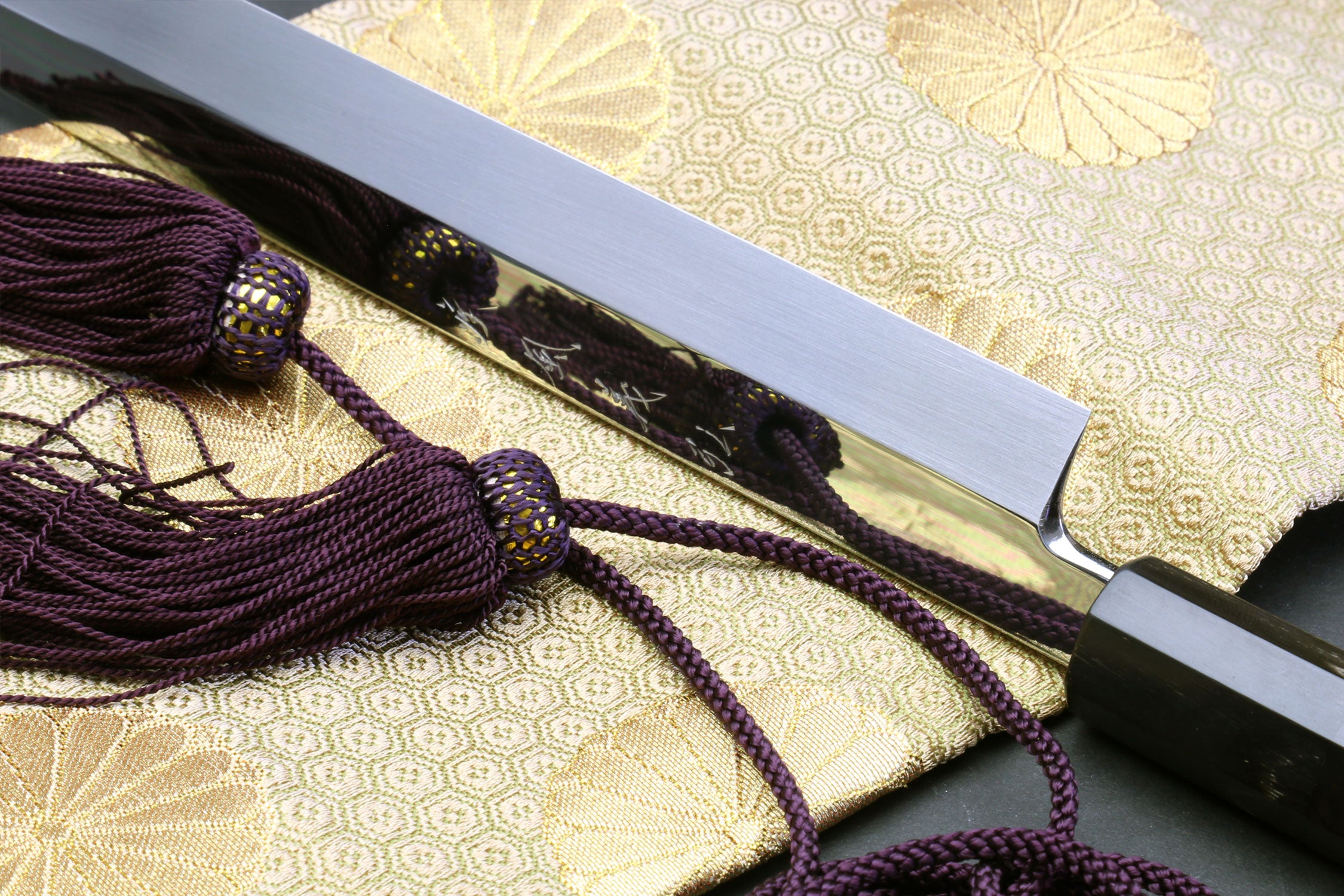 Close-up of Sakimaru sushi knife handle and mirror-polished blade edge