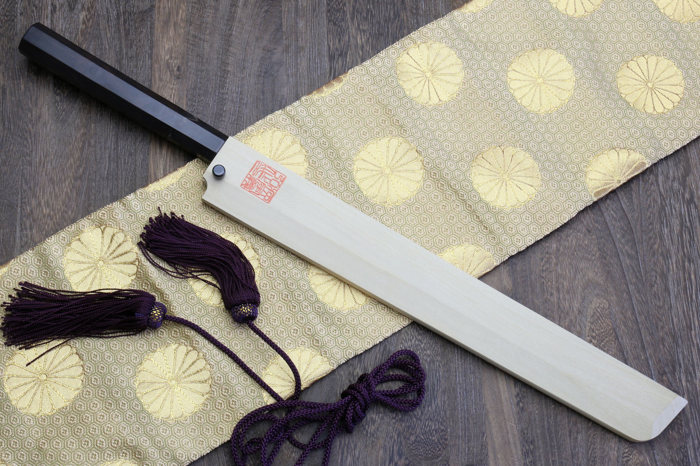 Japanese sushi knife with polished silver blade and dark handle