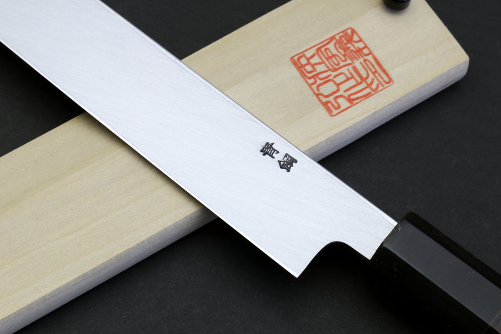 Sakimaru sushi knife with etched markings on polished blade