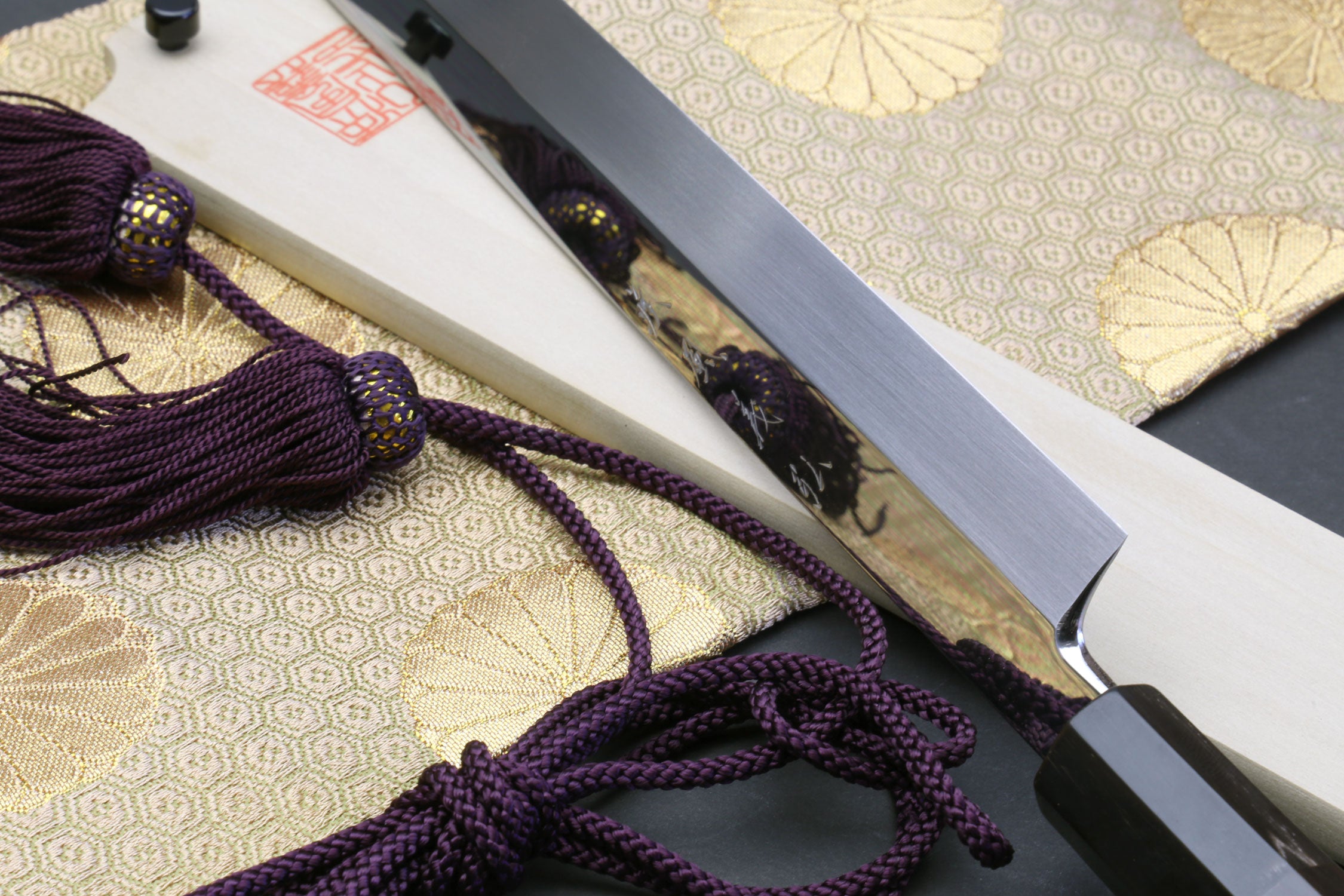Sakimaru sushi knife with cord-wrapped handle and polished blade