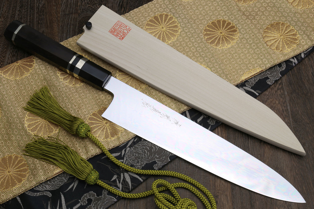 Gyuto Japanese chef knife with mirror-polished blade and ebony handle with striped accents