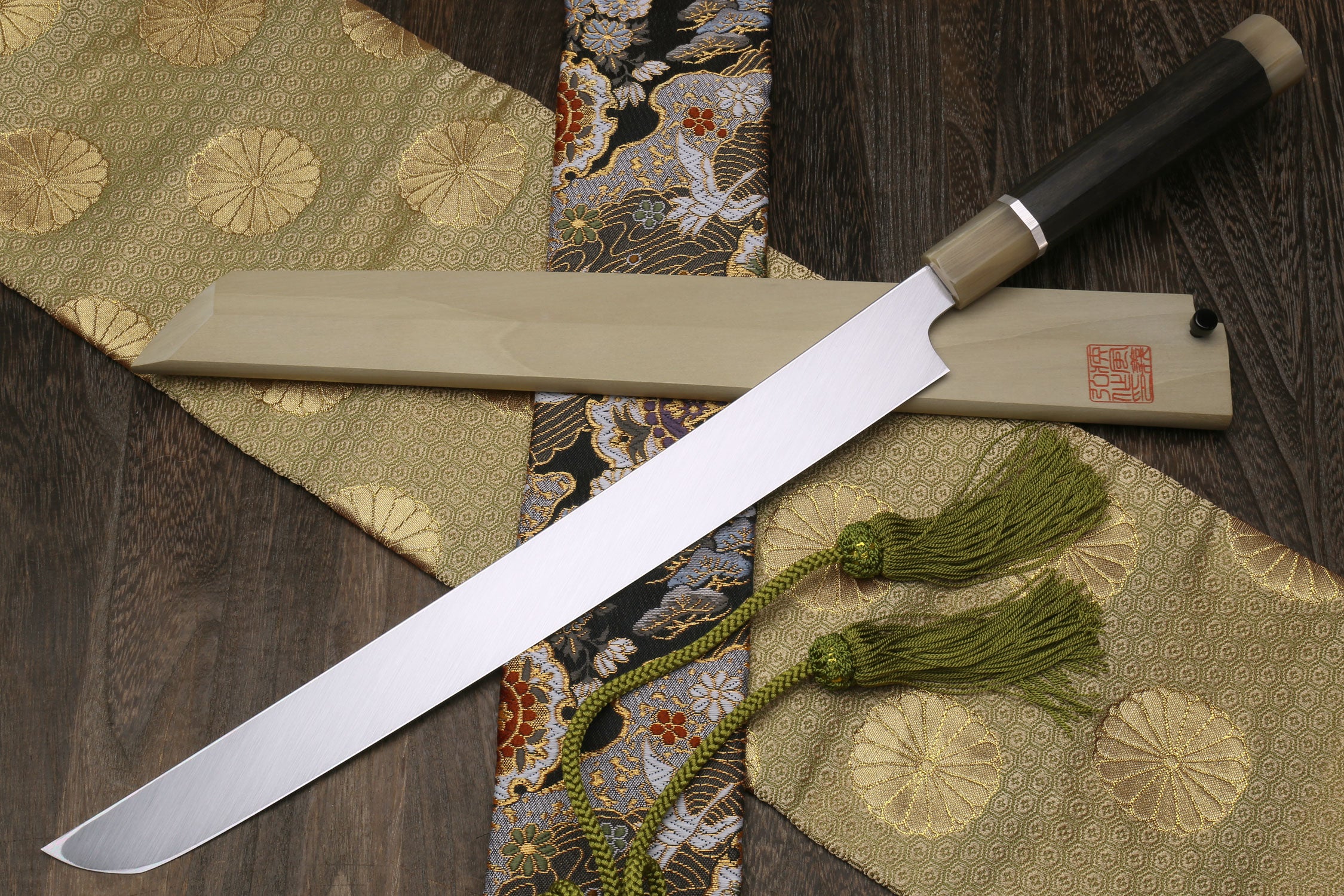 Japanese katana sword with silver blade, matching sheath, dark handle with light cap.