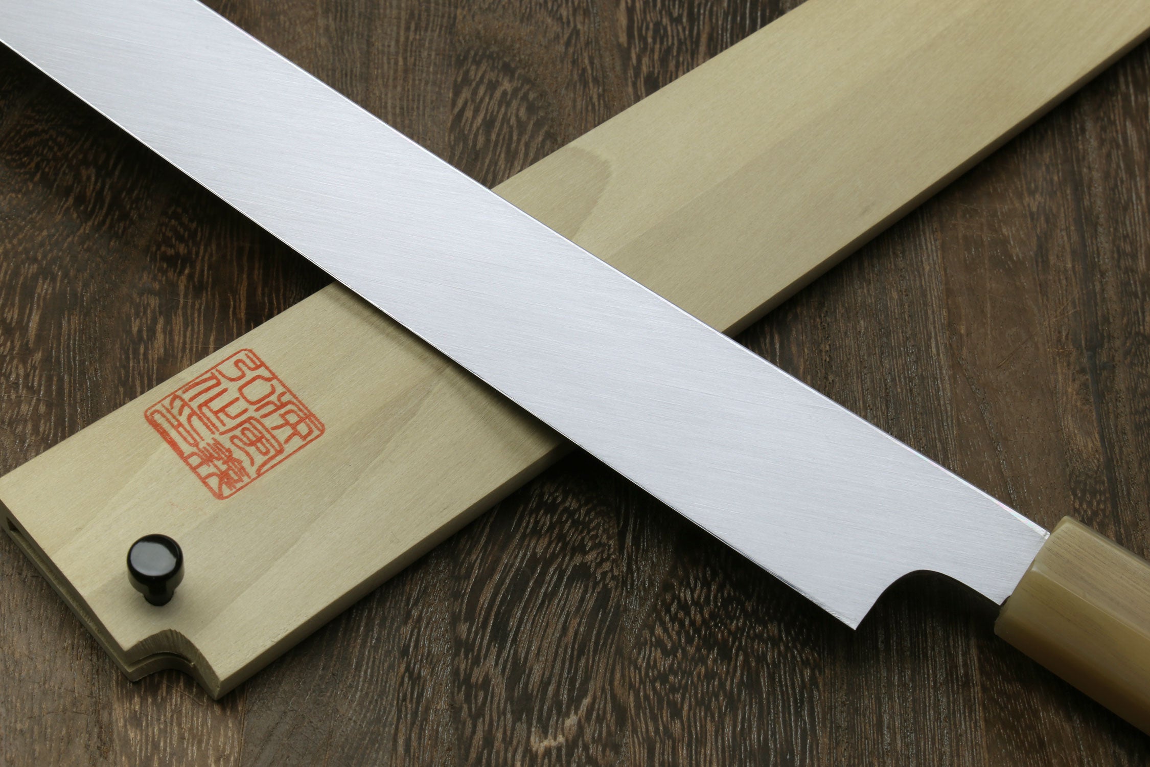 Japanese katana sword with scabbard, red seal panel, and silver blade.