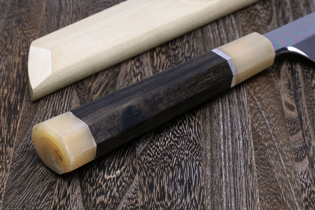 Japanese katana sword with dark handle and silver guard, light wood fittings.