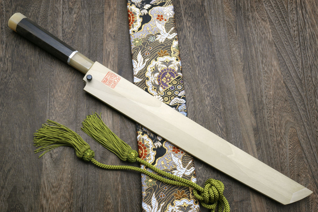 Mirror-finished Japanese knife with dark ebony handle and ornate dragon-pattern wrap