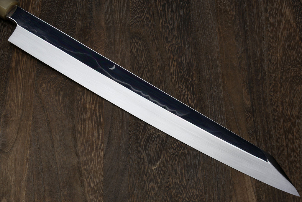 Yanagi kiritsuke knife with mirror-finished light steel blade and dark ebony handle