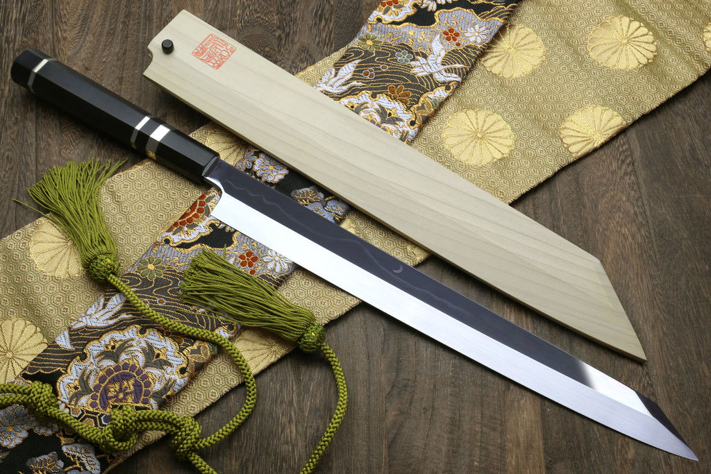 Yanagi kiritsuke knife side view with mirror-finished blade and dark ebony handle