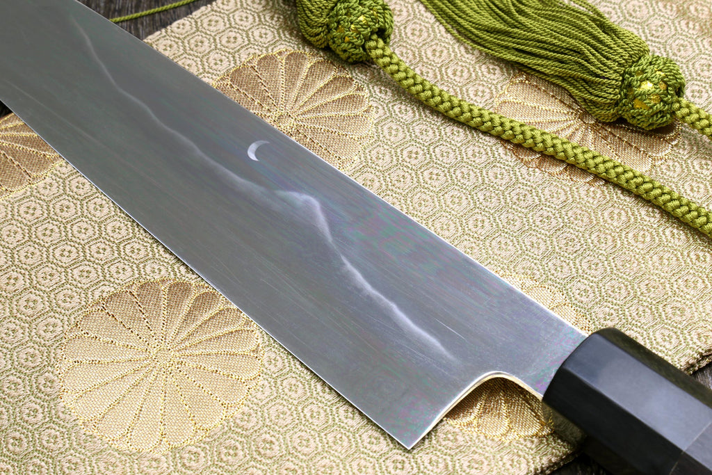 Gyuto chef knife blade detail with mirror finish and rounded tip