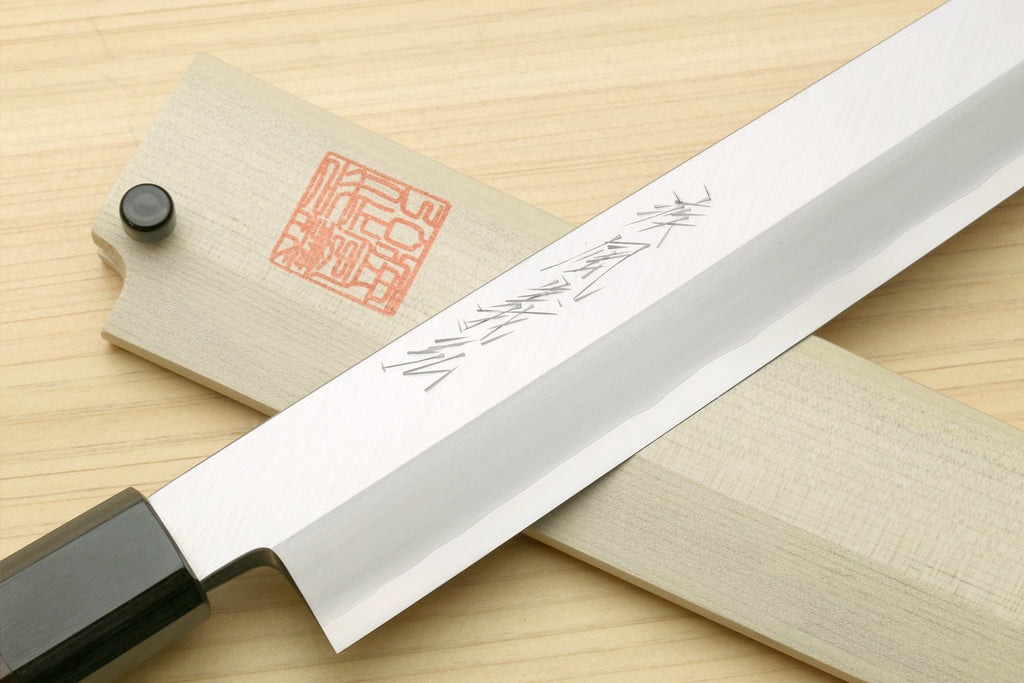 Sushi sashimi knife showing long silver blade with dark spine and rosewood handle