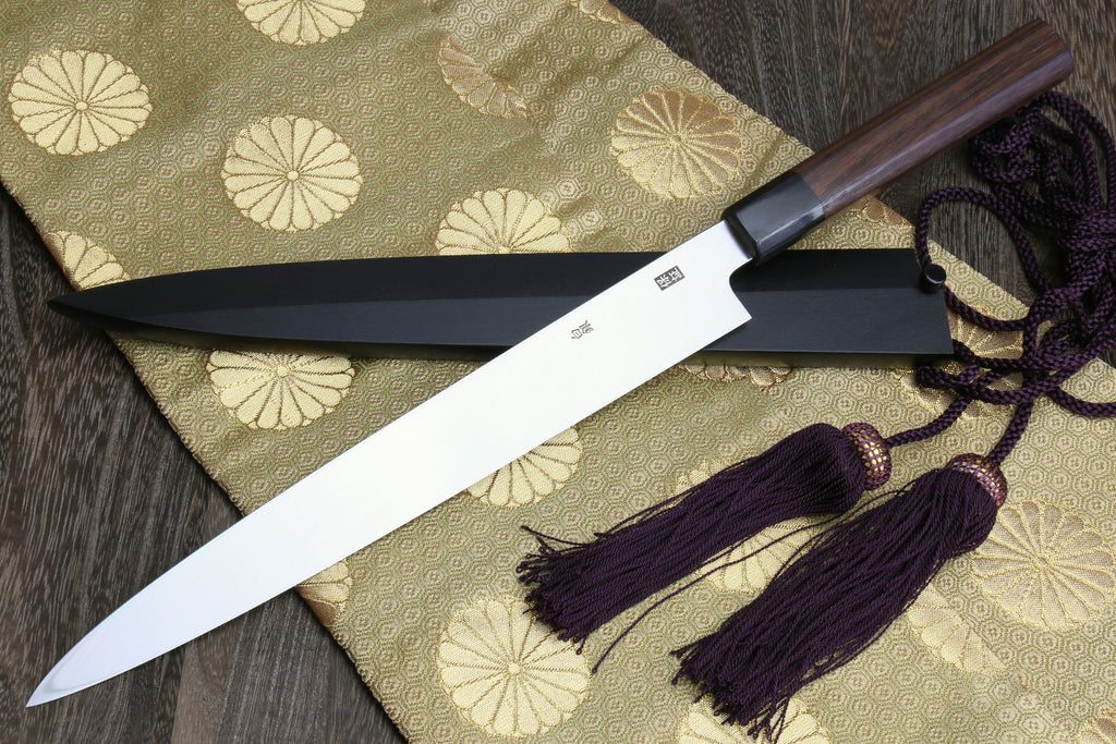 Japanese yanagi sushi knife with rosewood handle, dark saya, and purple cord tassels