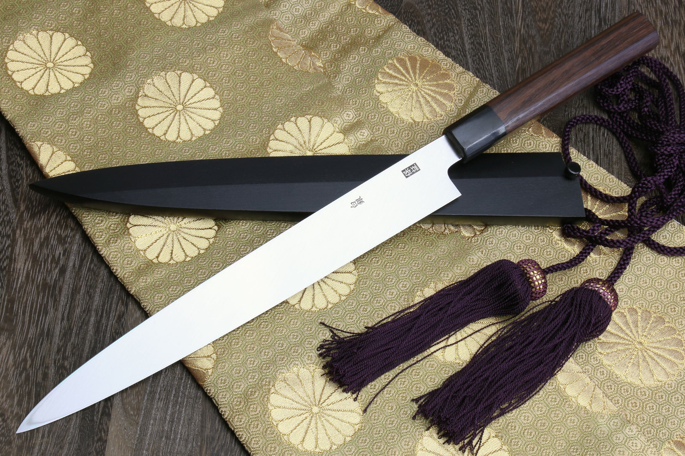 Japanese yanagi sushi knife with rosewood handle, dark saya, and purple cord tassels