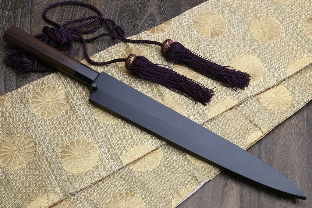 Yanagi sushi knife with dark saya, rosewood handle, and purple cord tassels