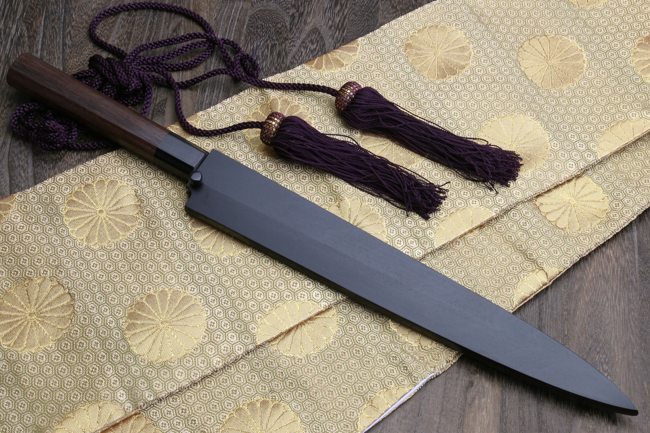 Yanagi sushi knife with dark saya, rosewood handle, and purple cord tassels