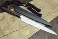Yanagi sashimi knife with stainless blade, rosewood handle, and purple tassels