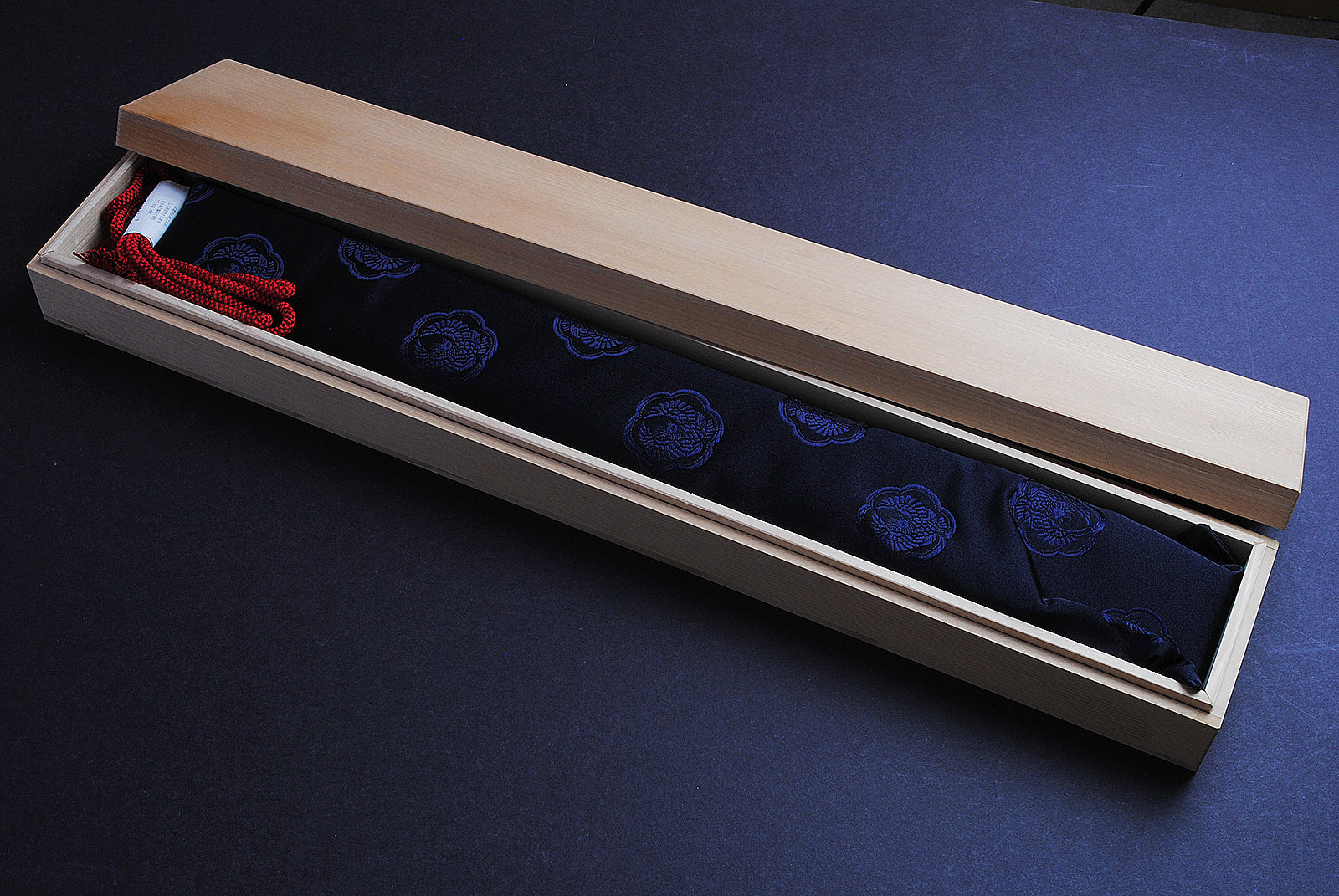 Knife in wooden saya gift box with blue lining and red accessory