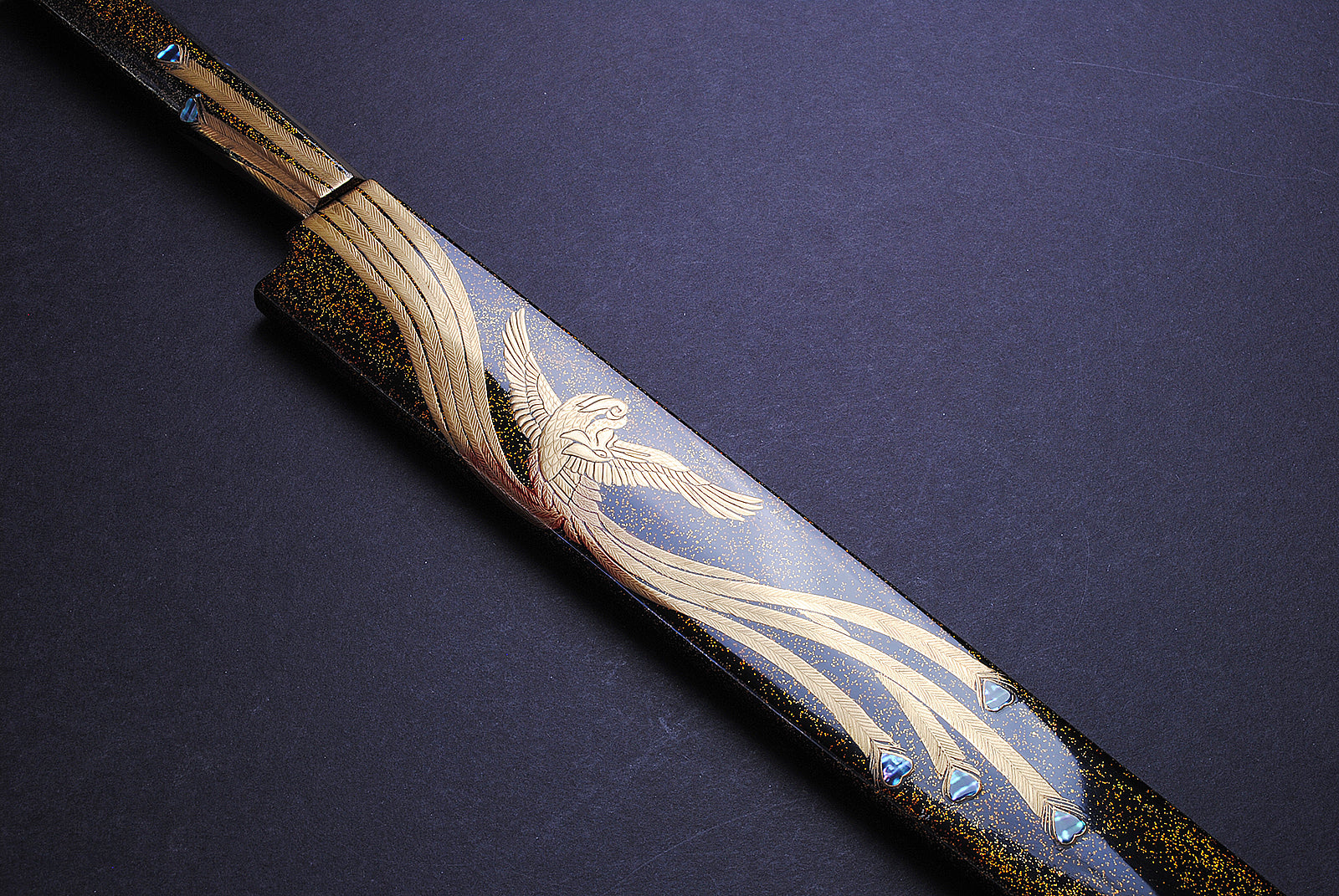 Yanagi kiritsuke knife handle with gold wavy details and phoenix-style engraving on blade