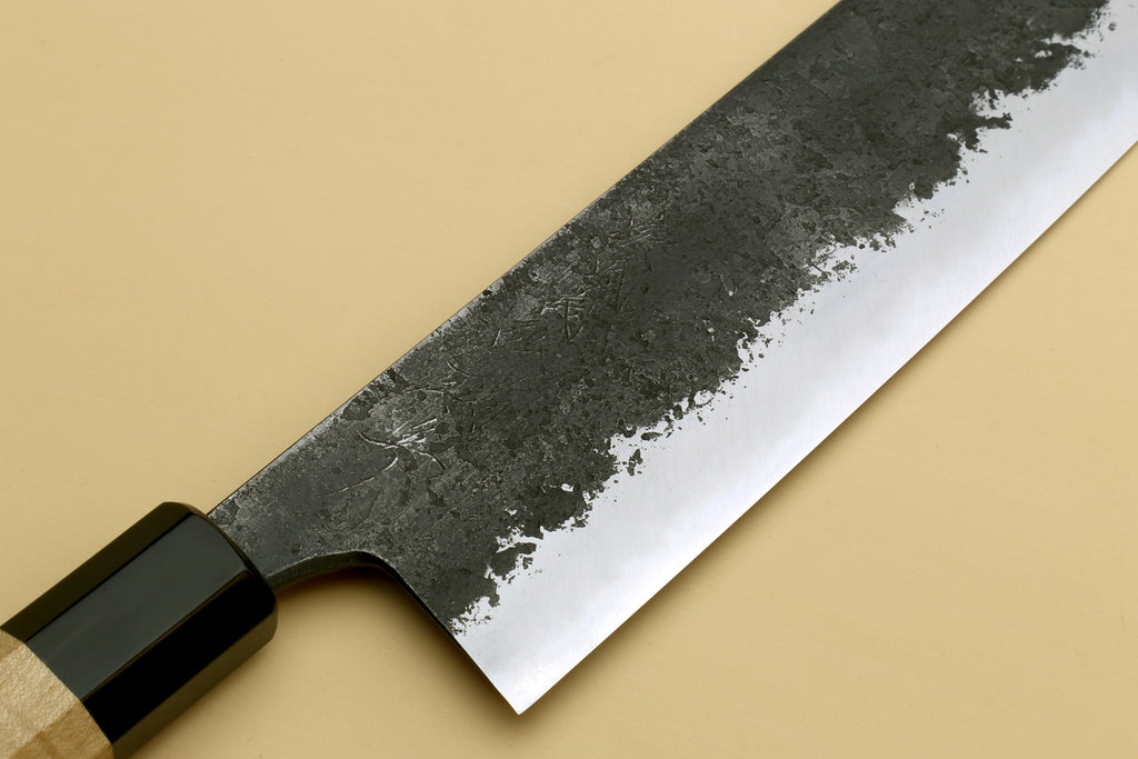 Nakiri knife close-up, dark steel blade with textured finish and wood handle