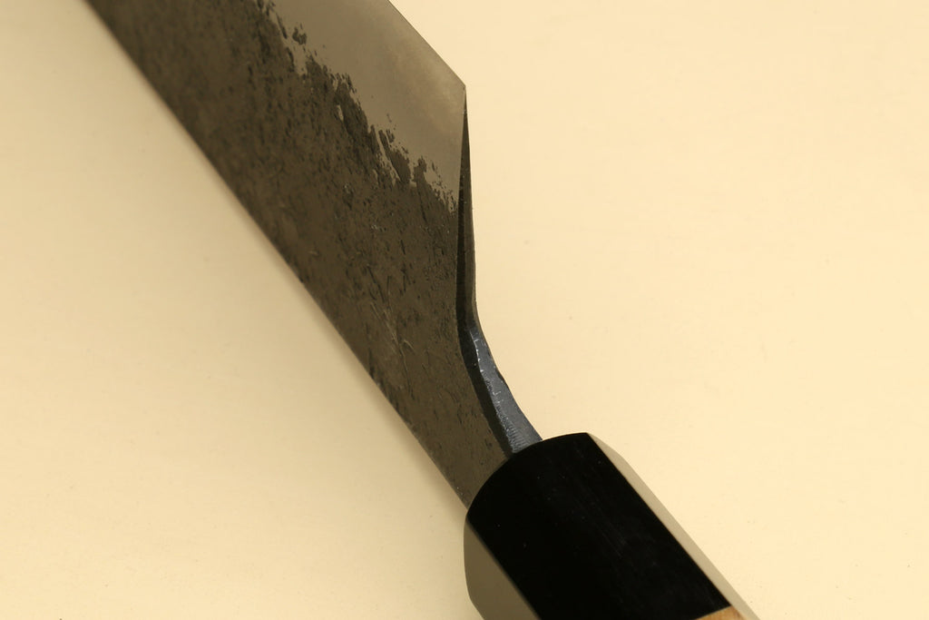 Nakiri knife tip and blade curve, textured dark steel blade with black guard