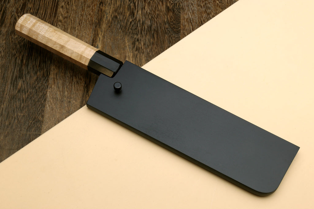 Nakiri knife with saya cover, dark blade and camphor wood handle in black sheath