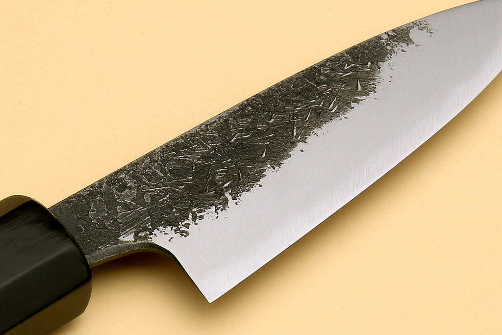 White-steel paring knife blade with speckled finish and curved cutting edge