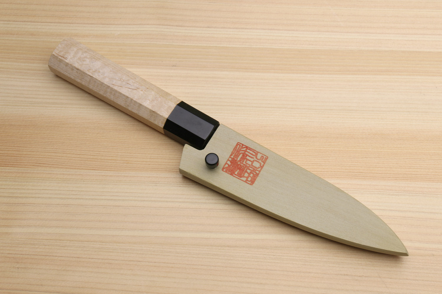 Japanese paring knife with speckled white-steel blade and camphor wood handle, black bolster