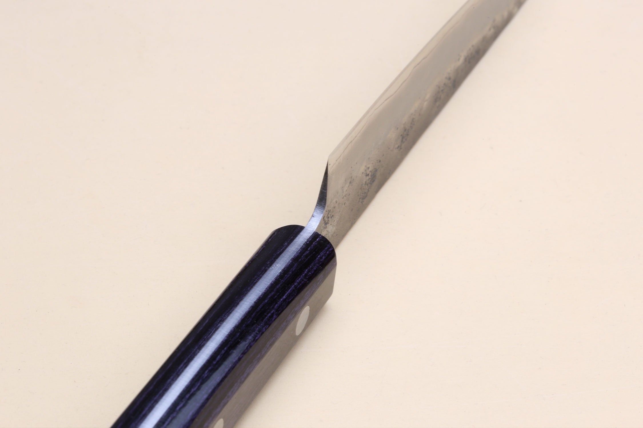 Petty utility knife with dark glossy handle and silver blade, pointed tip