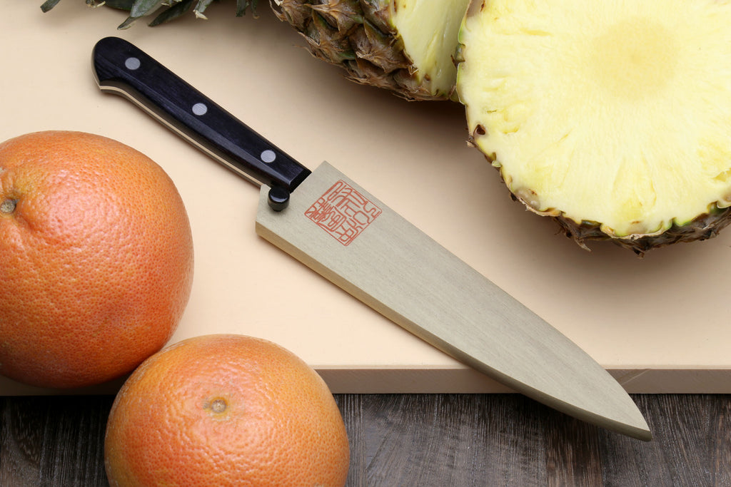 Petty utility knife with dark handle, silver blade, and wooden sheath with red stamp