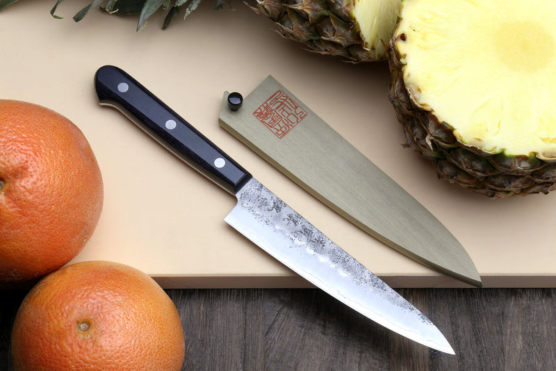 Petty utility knife with dark handle, silver blade, and light wooden sheath
