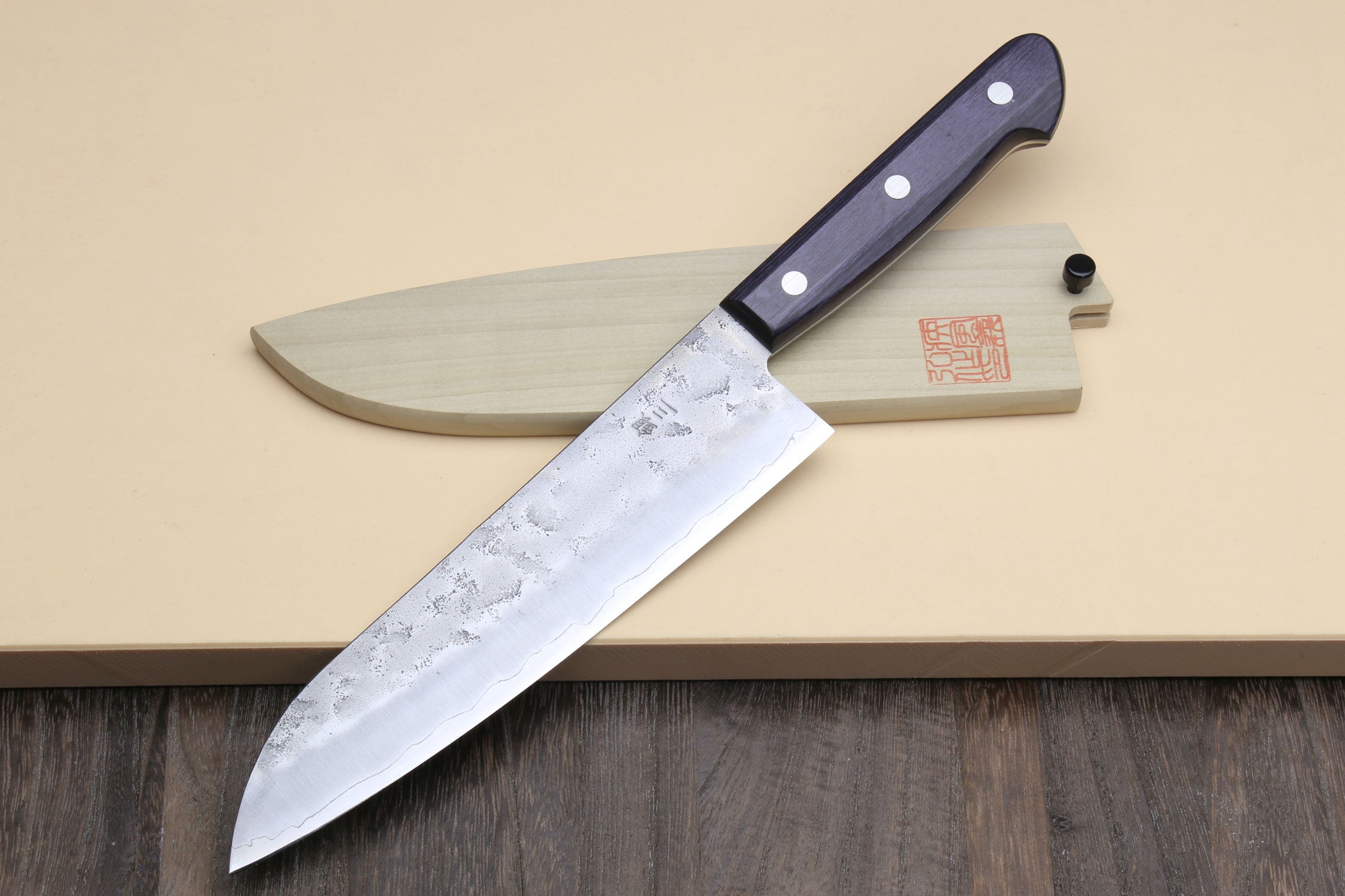 Santoku knife with dark blue handle and silver curved blade