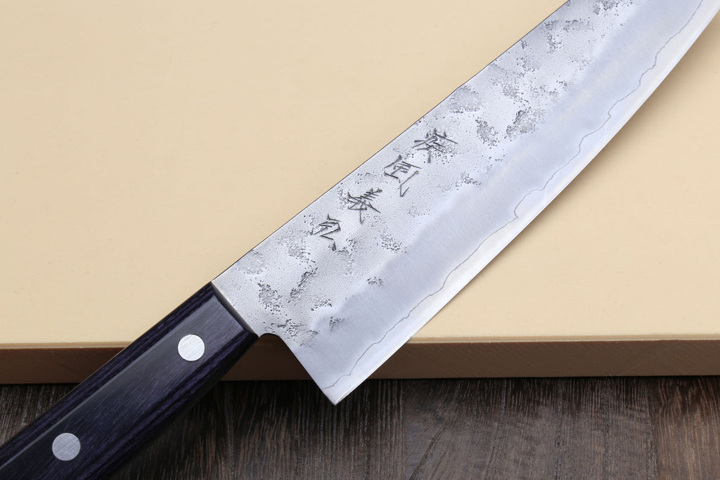 Santoku knife blade close-up, silver finish with etched characters