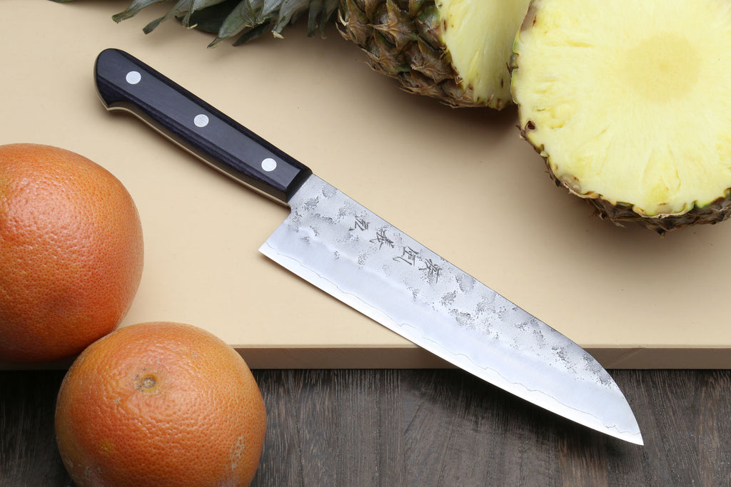 Santoku knife with dark blue handle and silver blade with etched pattern