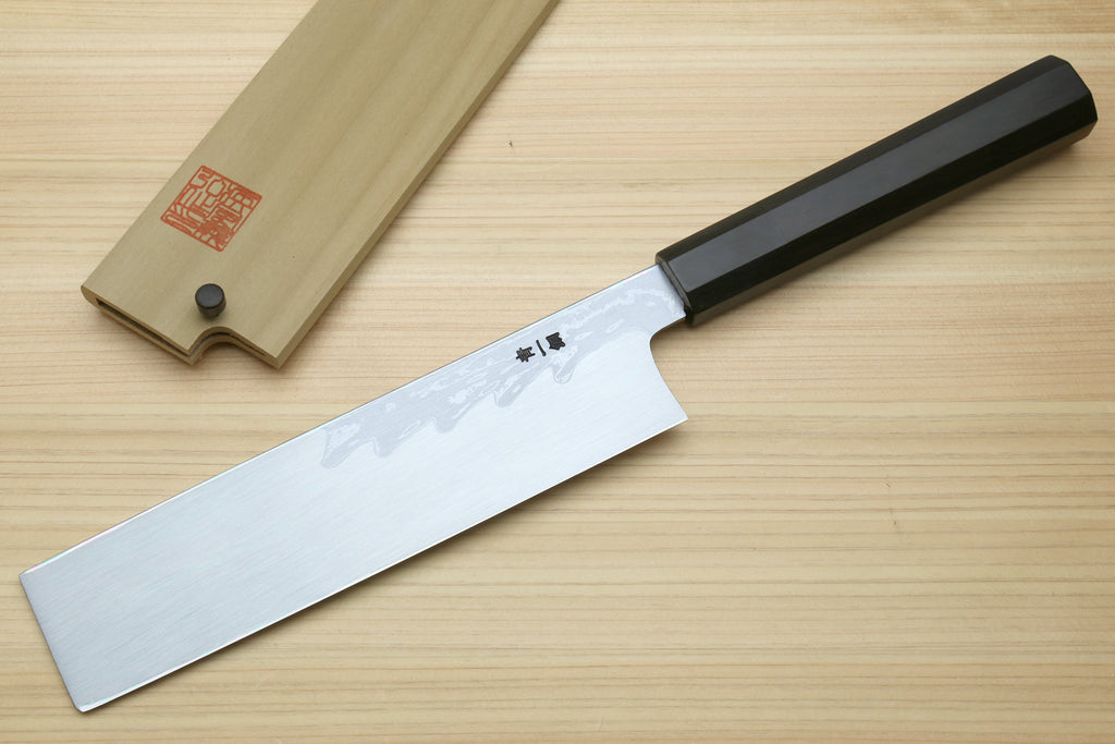 Japanese vegetable prep knife with long white damascus blade and black ebony handle