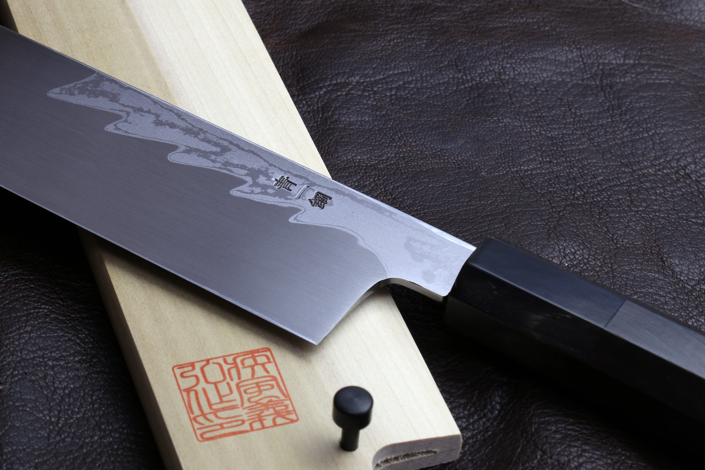 Japanese vegetable prep knife with damascus blade and engraved characters, ebony handle