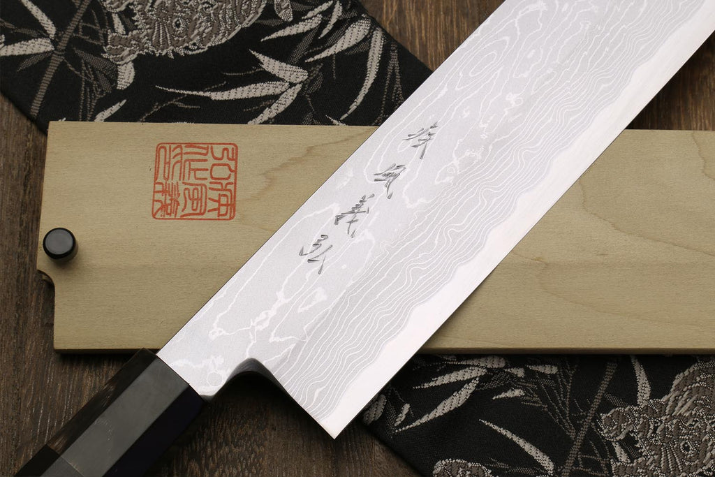 Traditional Japanese vegetable chopping knife with white damascus blade and wooden sheath