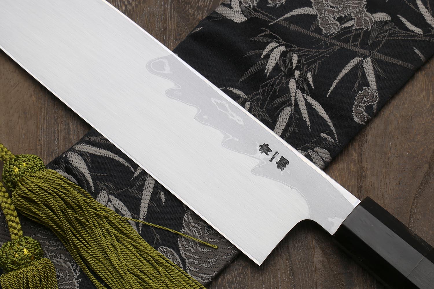 Traditional Japanese vegetable chopping knife with white damascus blade, black handle