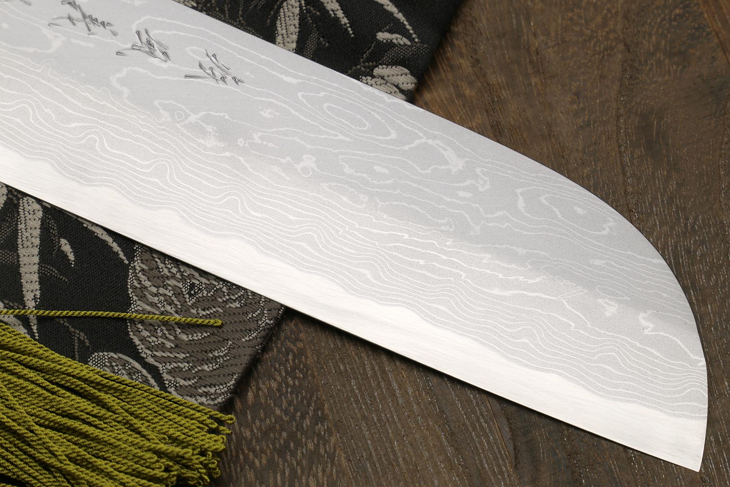 White damascus-style knife blade with wave pattern and curved tip